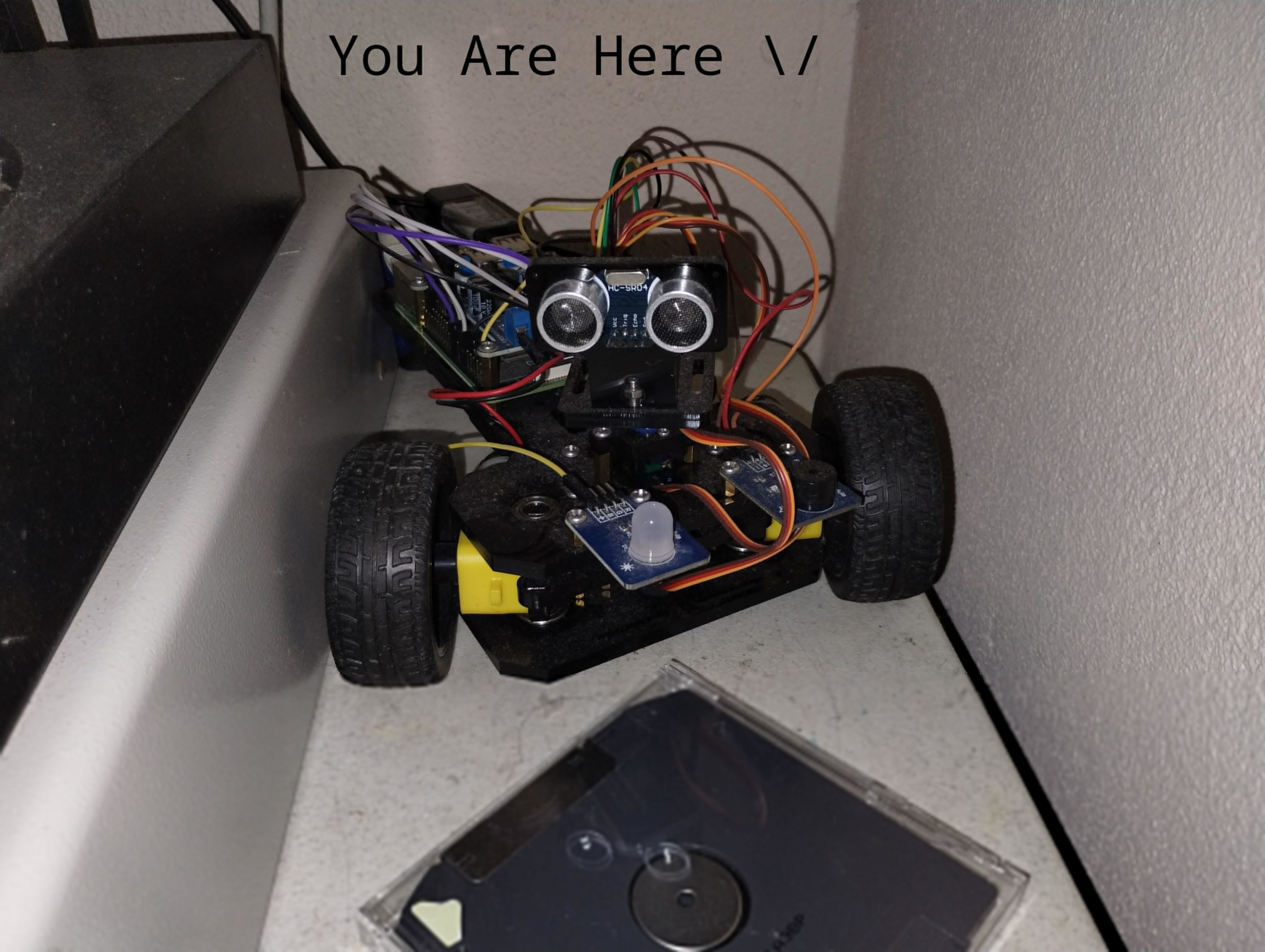 You Are Here, RC car with a scramble of wires and an ultrasonic sensor that look like eyes